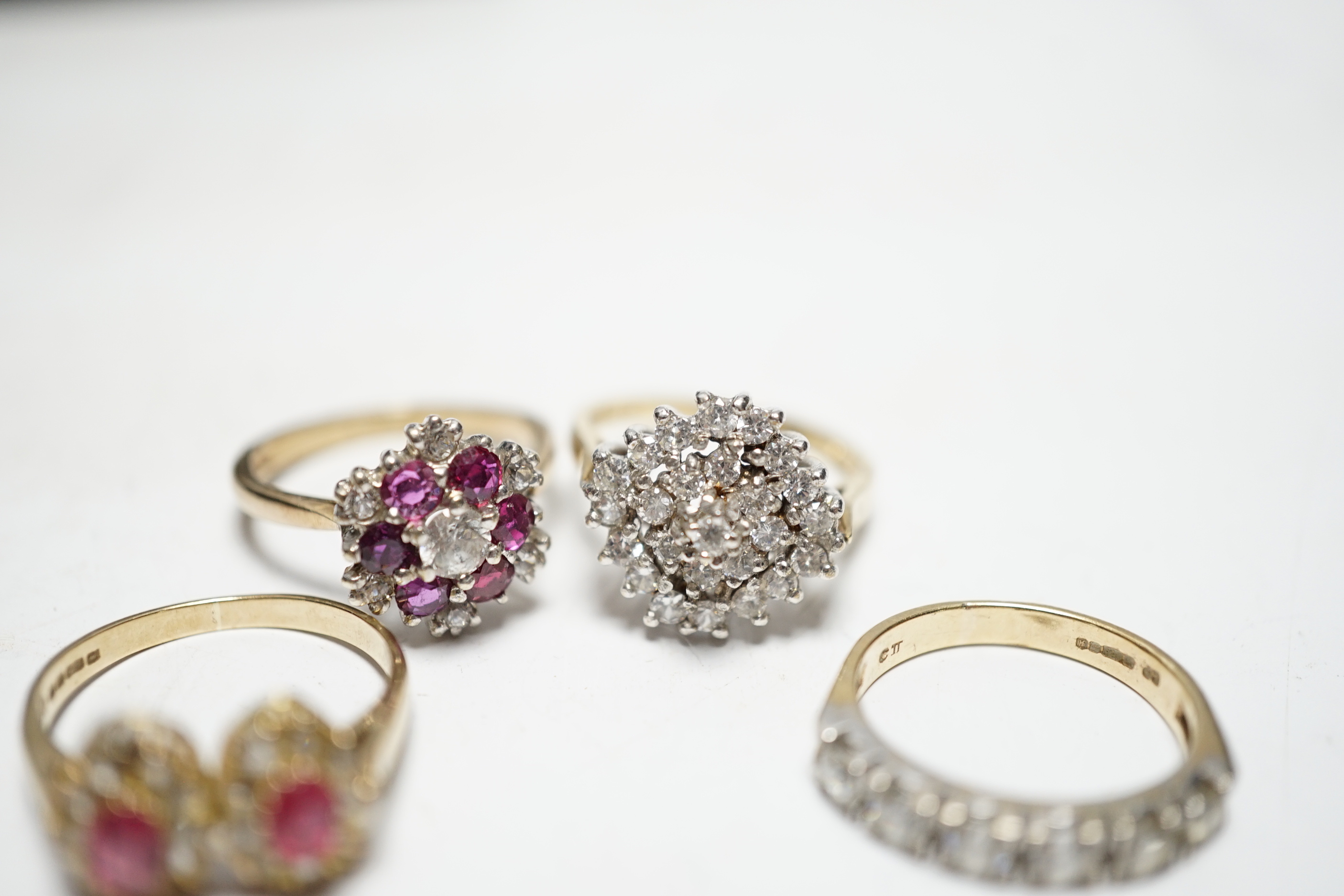 A modern 9ct gold, ruby and simulated diamond cluster set flower head ring, size N and three other assorted 9ct rings including CZ and two colour paste, gross weight 12.4 grams.